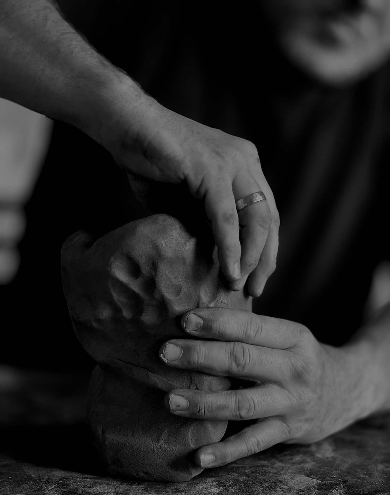 Hands shaping clay